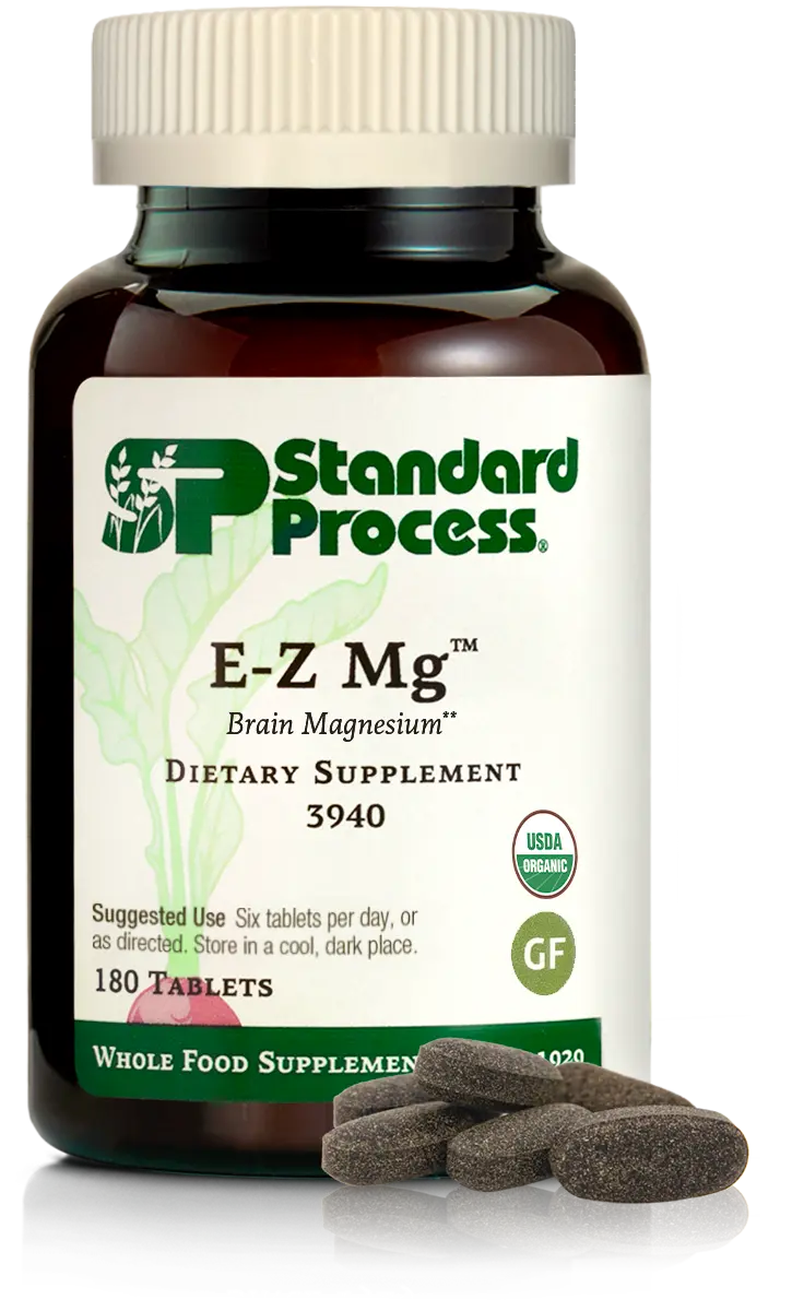 Image of E-Z Mg bottle next to tablets of magnesium supplements.